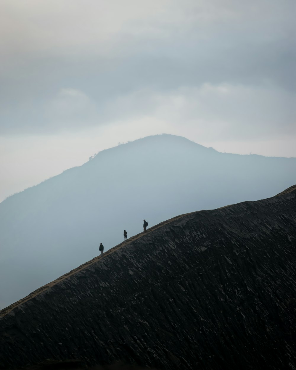 a group of people standing on top of a mountain