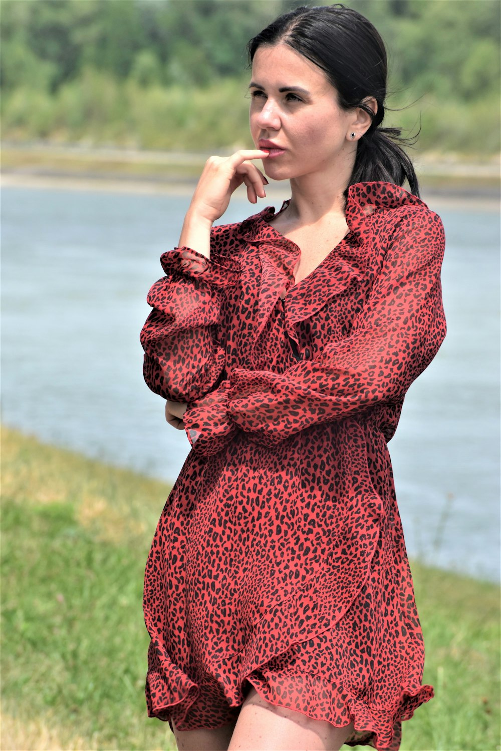 a woman in a red dress posing for a picture