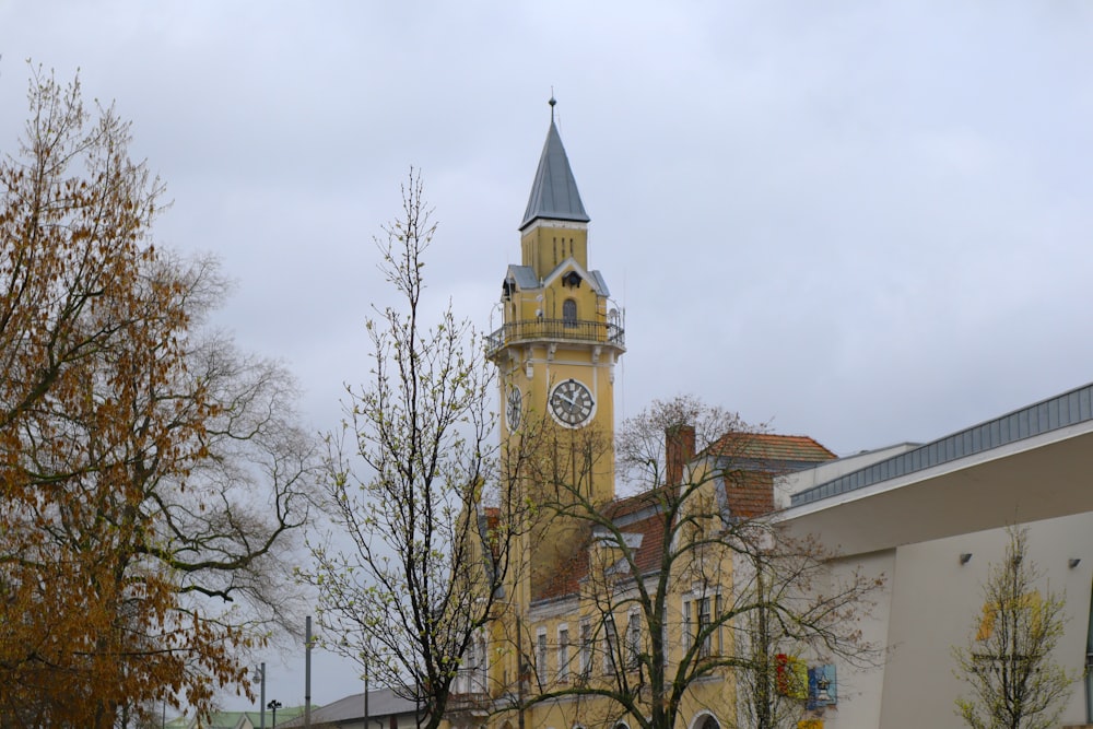 a tall clock tower with a clock on each of it's sides