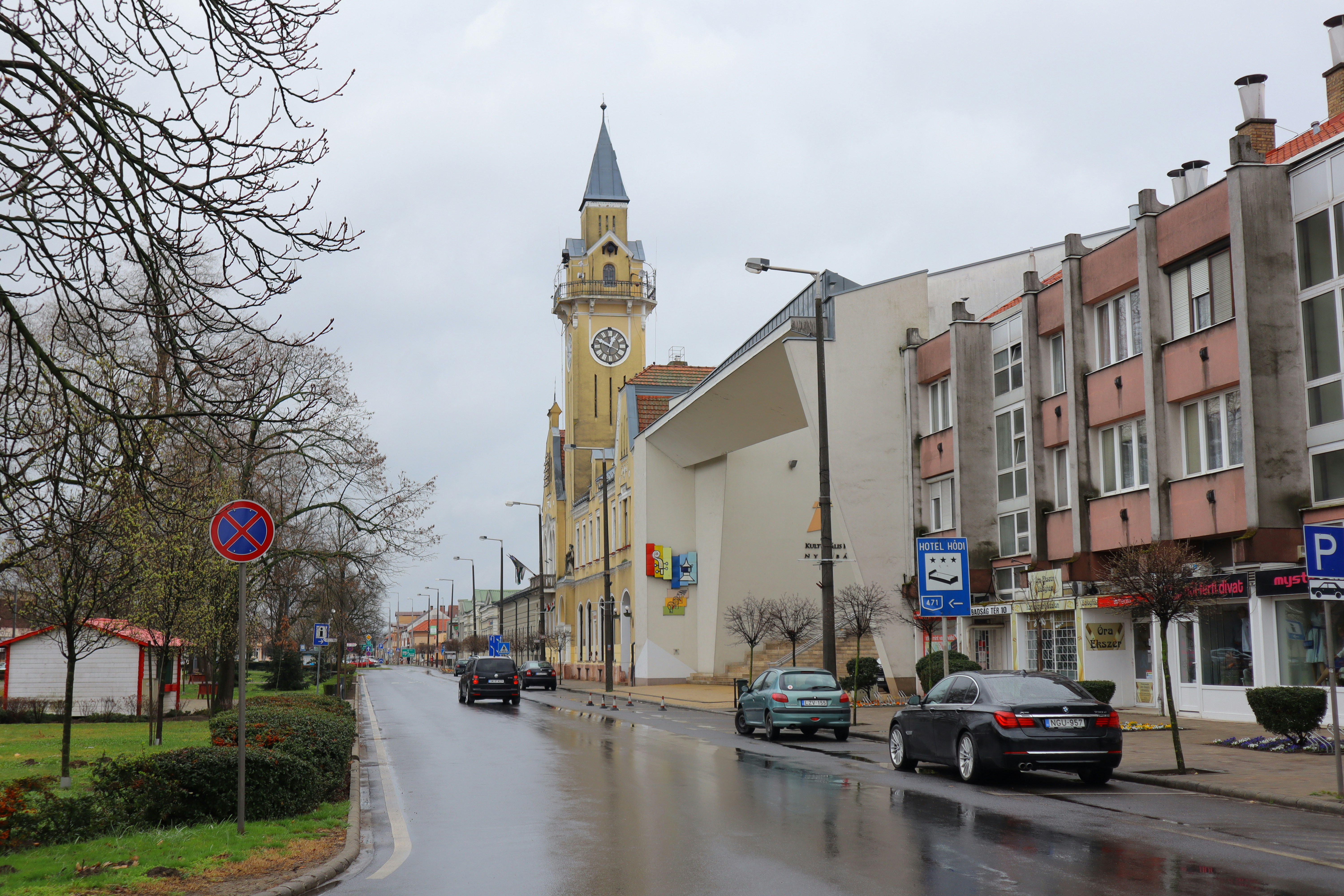 a city street with a clock tower in the background