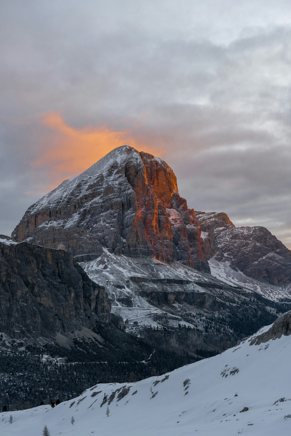 a snow covered mountain with a sunset in the background