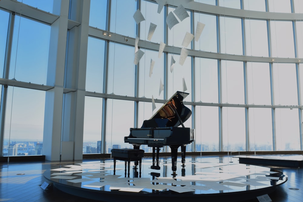 a grand piano in front of a large window