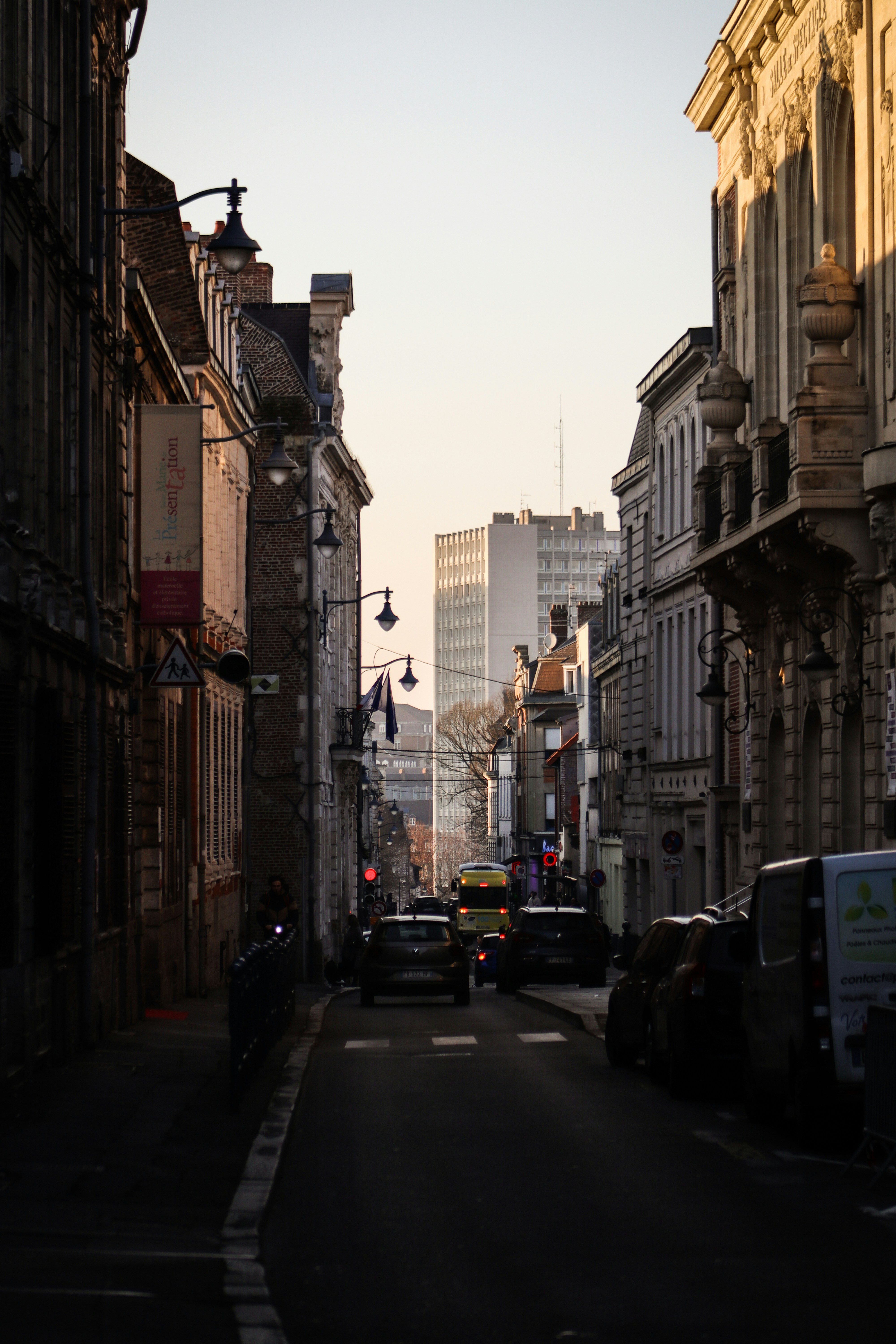 a city street lined with tall buildings and traffic lights