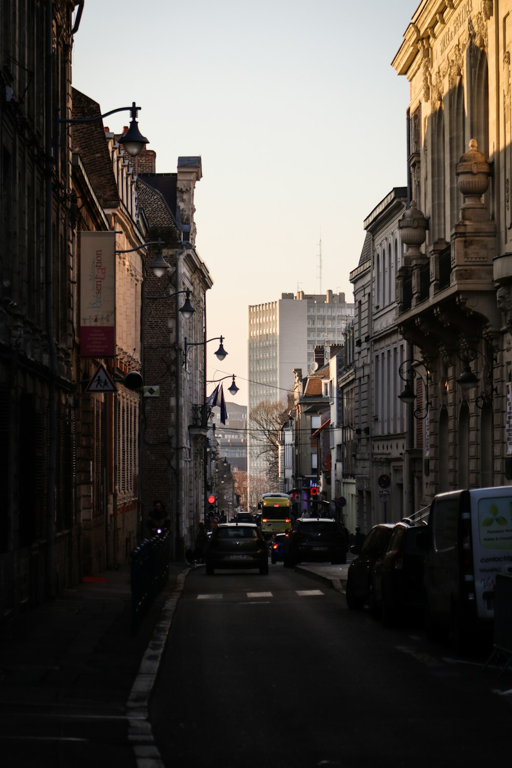 a city street lined with tall buildings and traffic lights