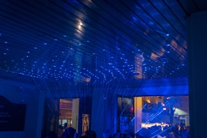 A family having fun together in a laser space, surrounded by futuristic decor.