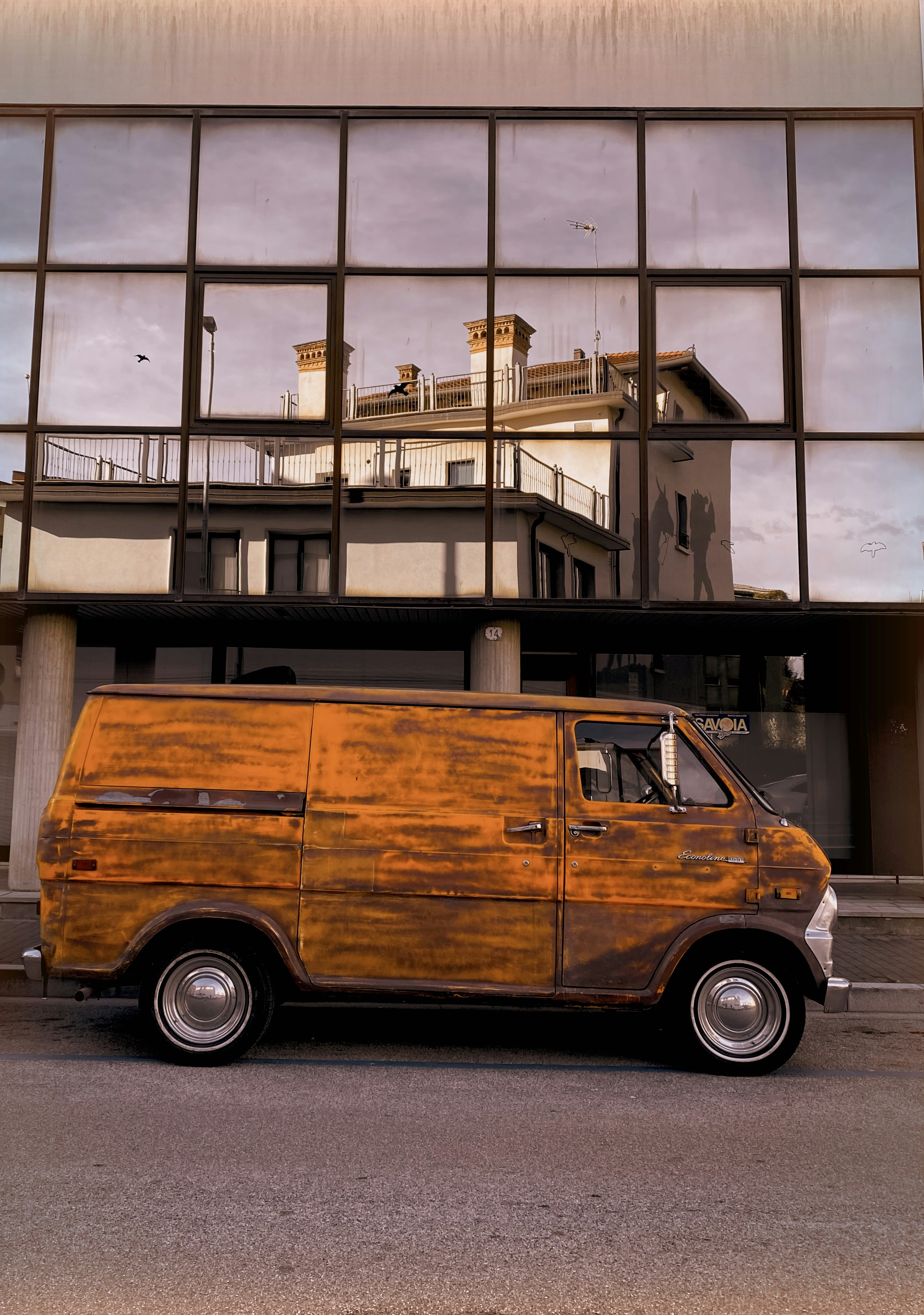 a van is parked in front of a building