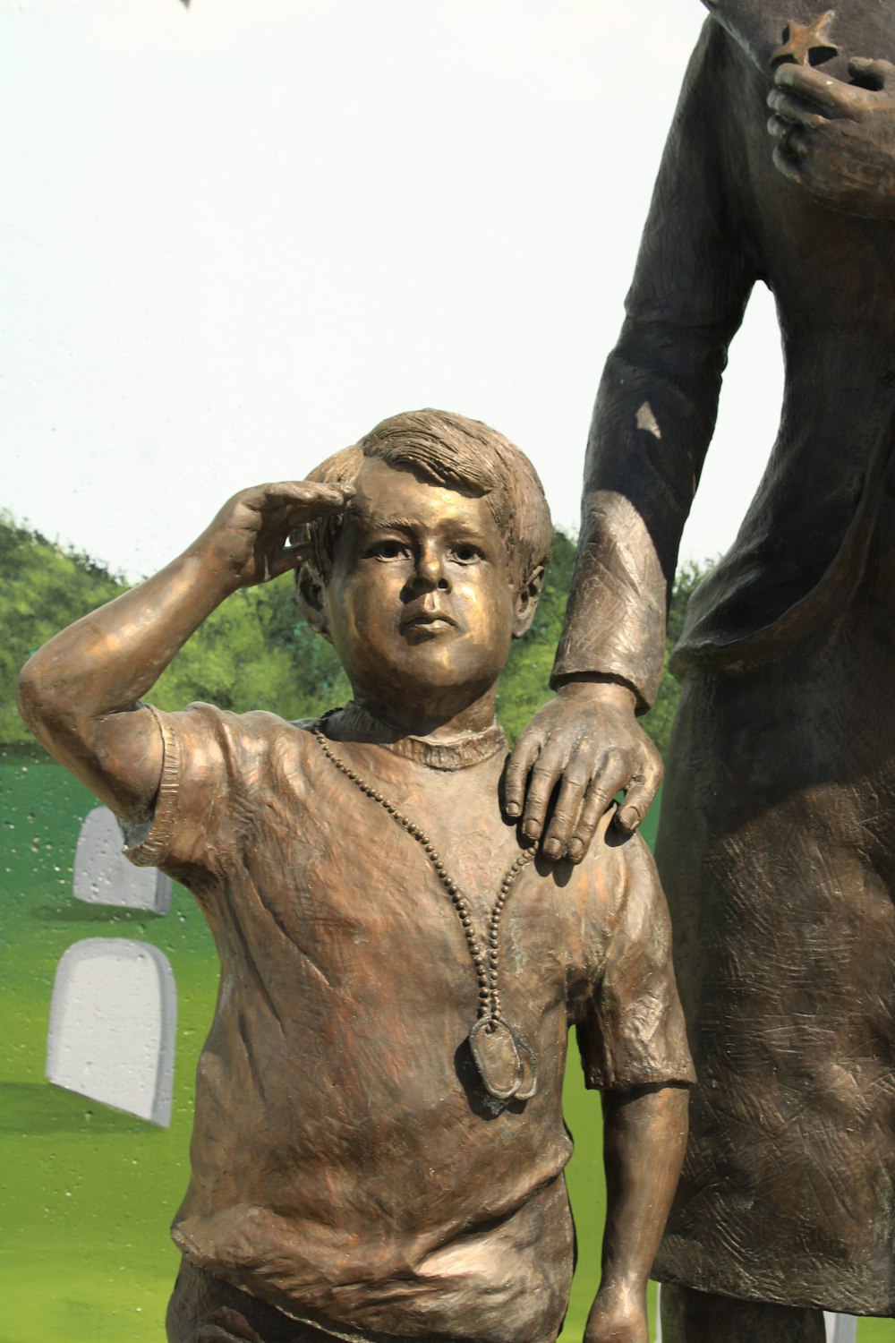a bronze statue of a woman holding a child's hand