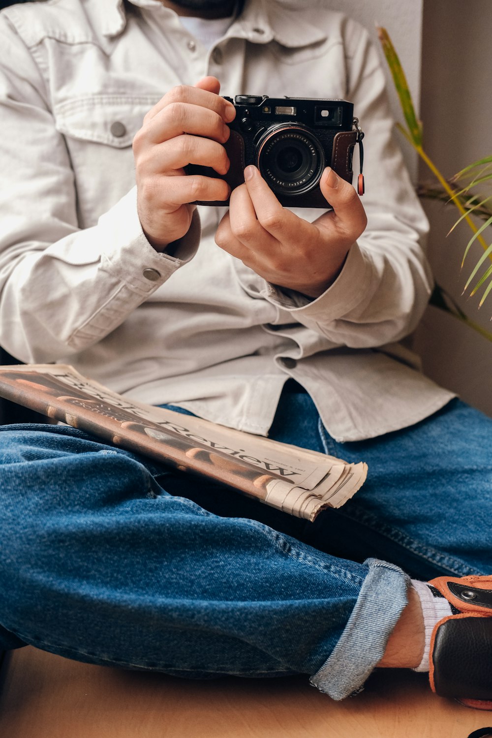 a man sitting on the floor holding a camera