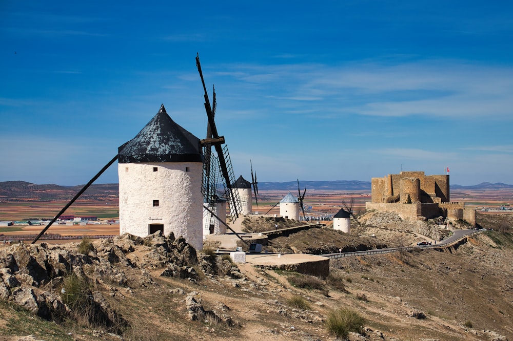 a windmill on top of a hill in the desert