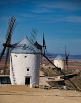 an old windmill sits in the middle of a desert