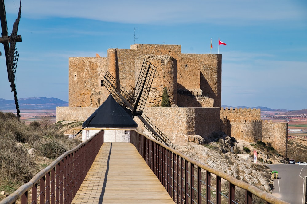 a wooden walkway leading to a castle like structure