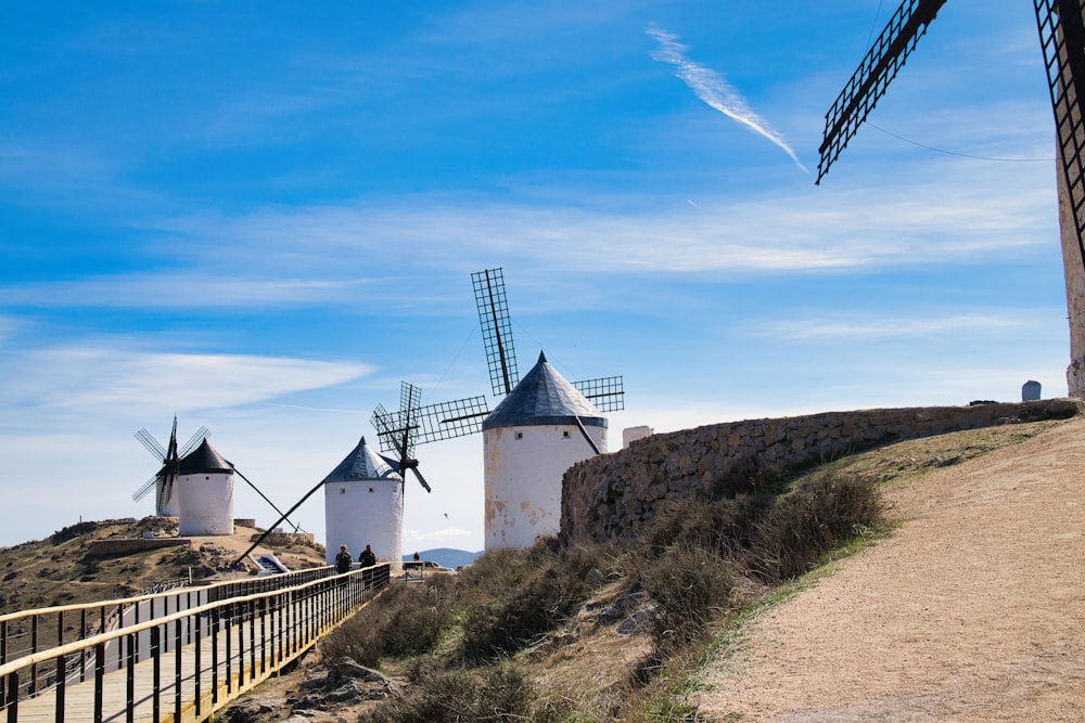 a couple of windmills that are on a hill