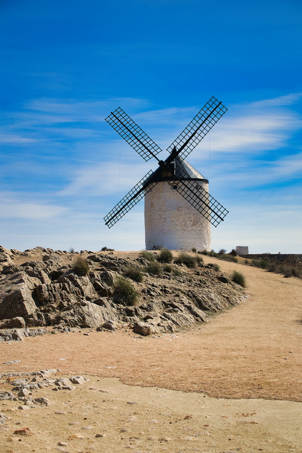 a windmill on top of a rocky hill