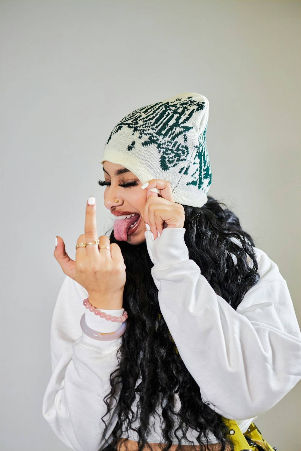 a woman with long black hair making a peace sign