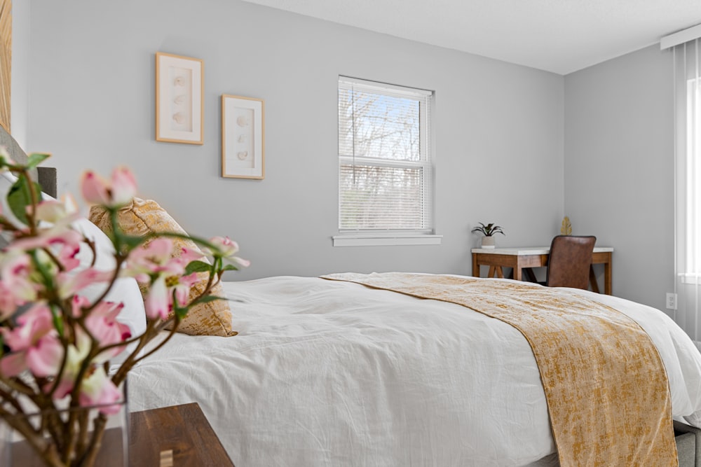 a bedroom with a bed, desk, and window