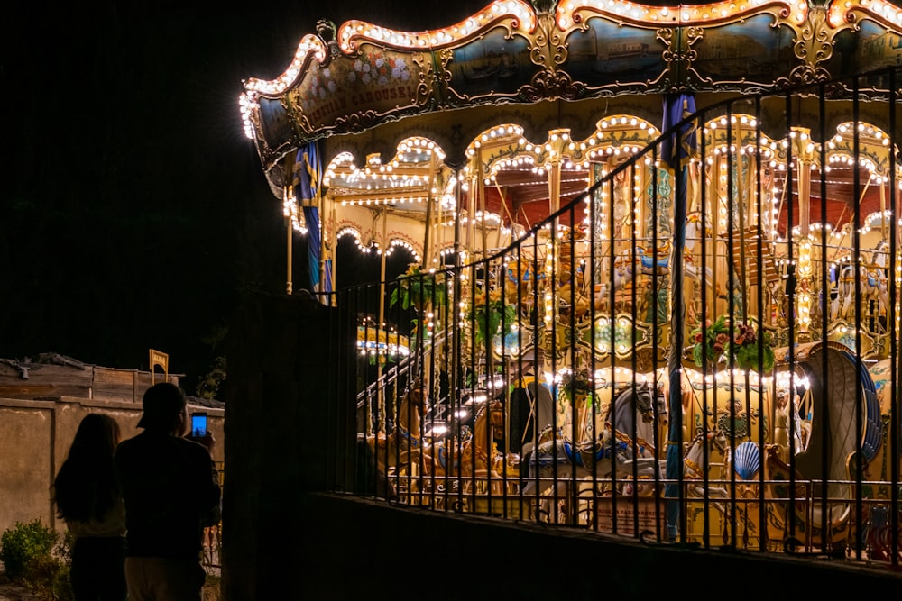 a merry go round is lit up at night