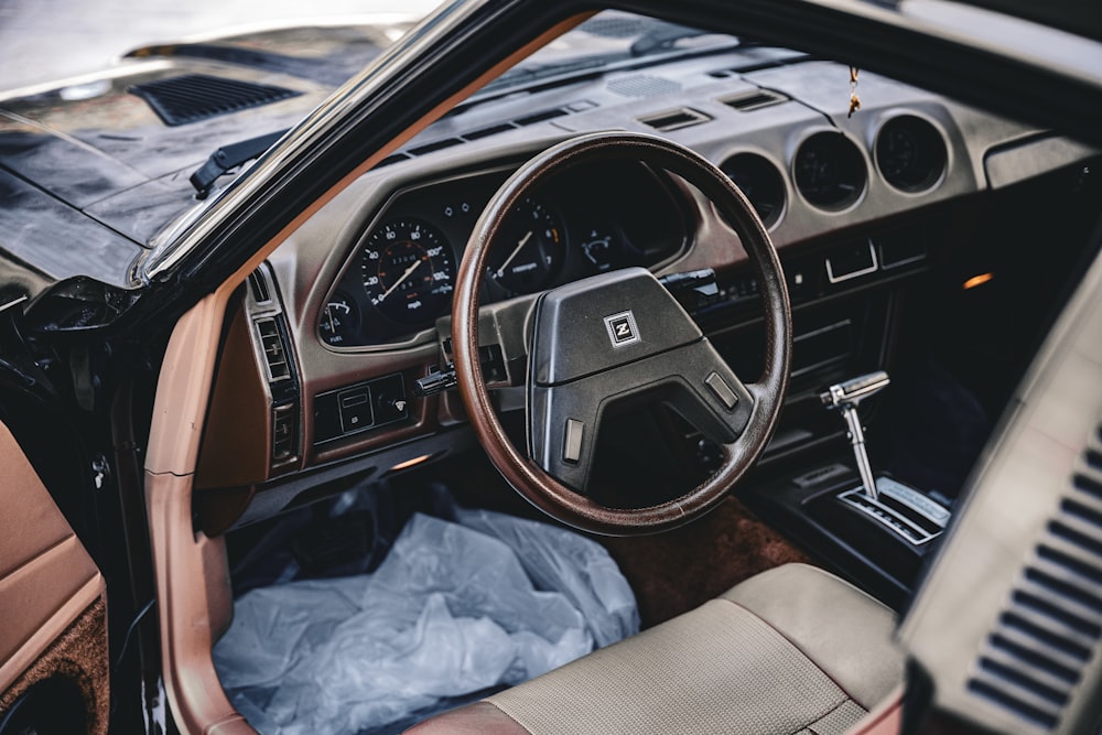 the interior of a car with a steering wheel and dashboard