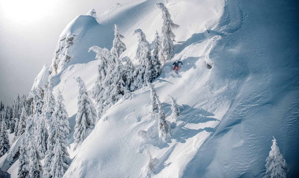 a person skiing down a steep snowy mountain