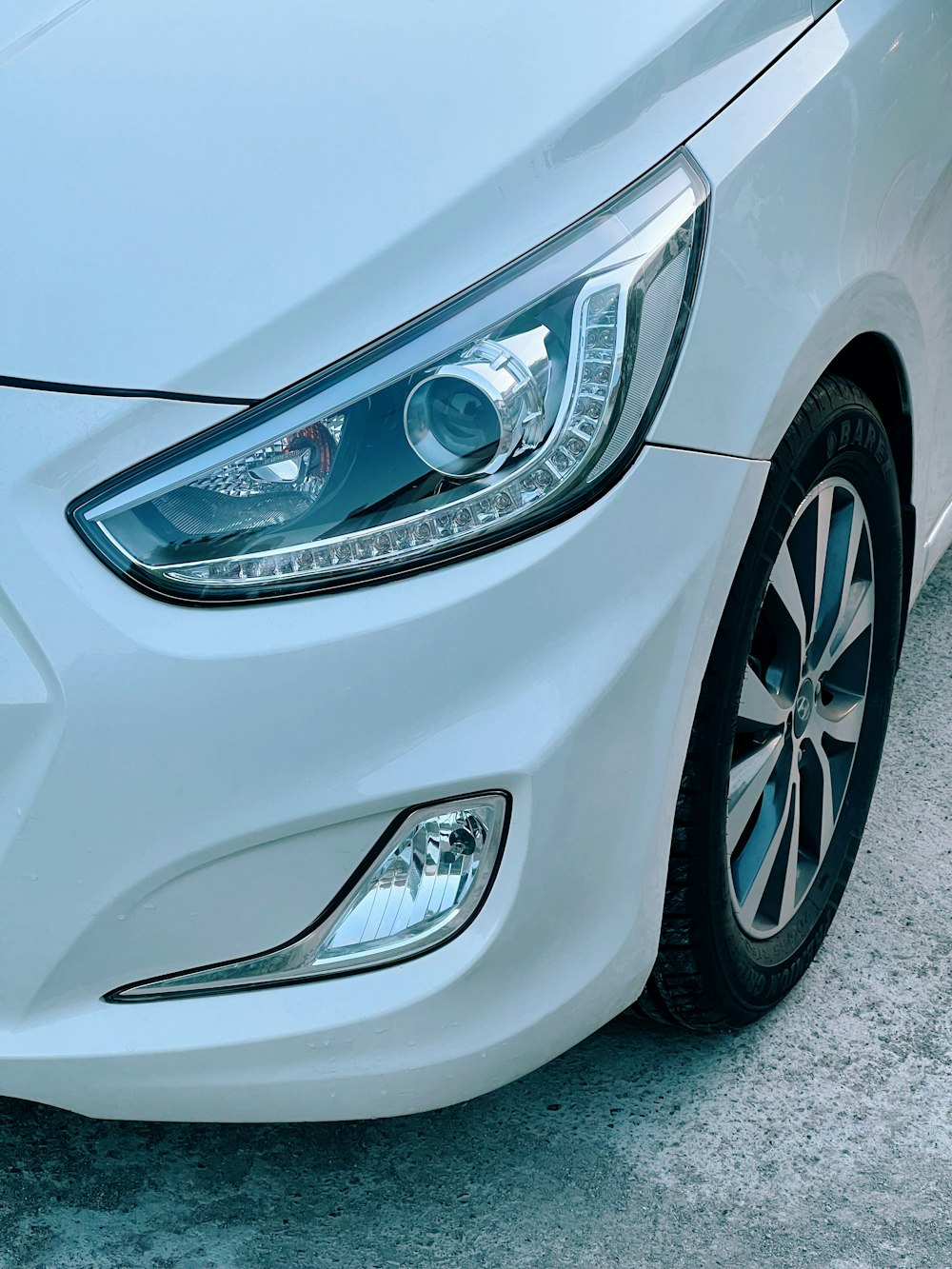 a close up of the front of a white car