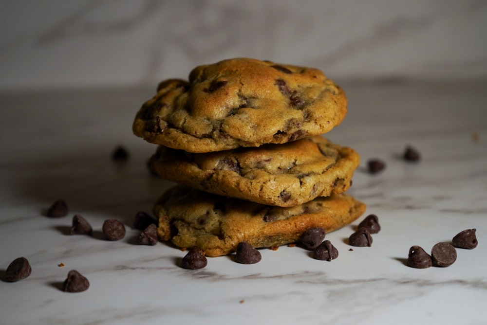 a stack of chocolate chip cookies on a marble surface