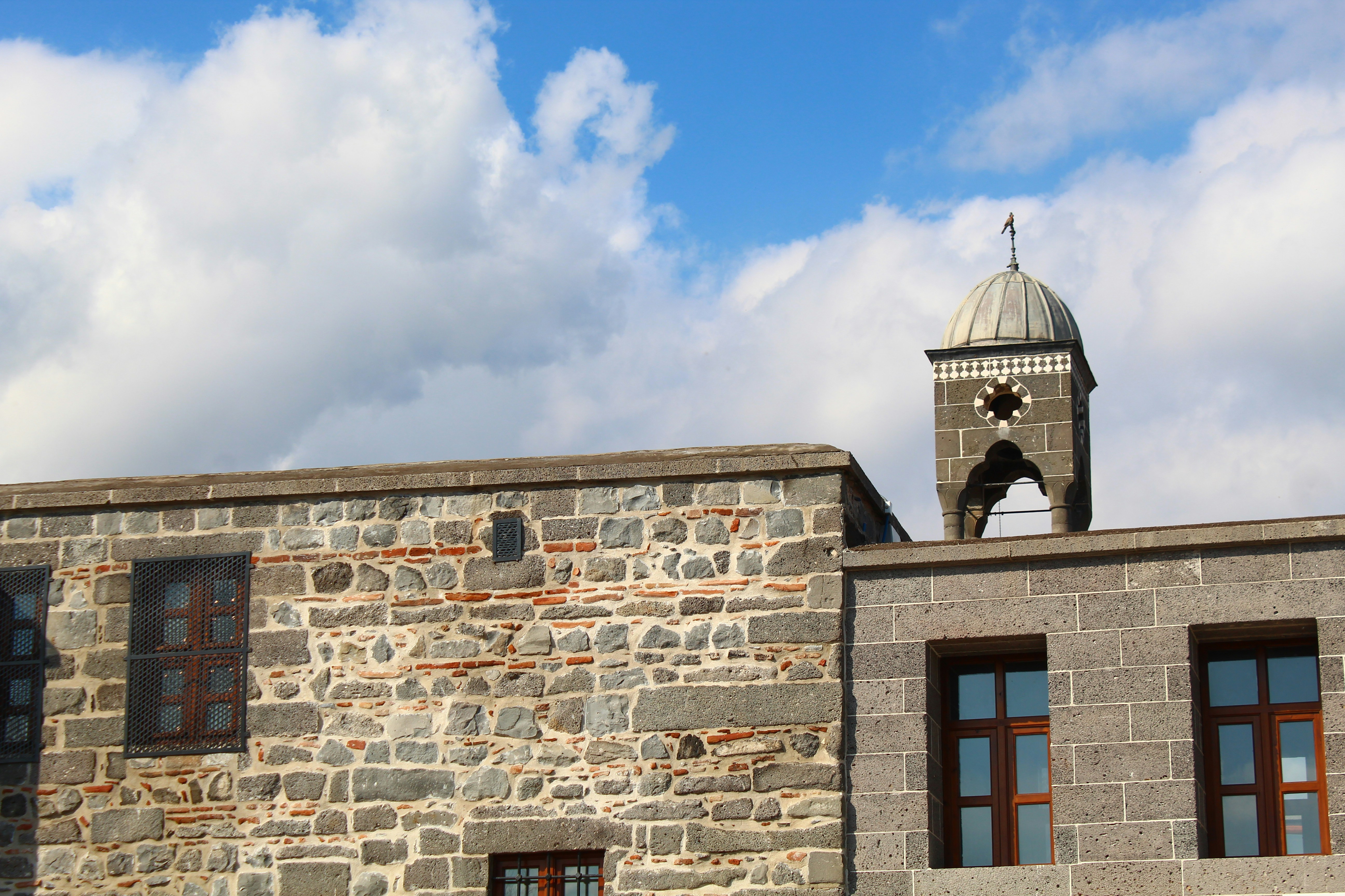 a stone building with a clock tower on top