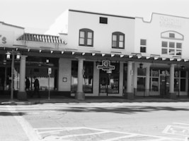 a black and white photo of a street corner