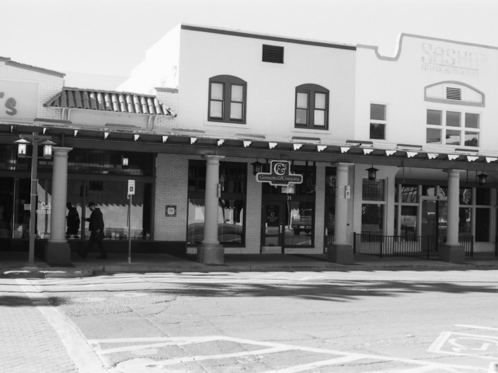 a black and white photo of a street corner