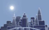 A digital cityscape with wireframe buildings in various heights and angular designs against a blue sky. The sun is positioned to the left, casting a bright glow, and the structures have a glowing outline.