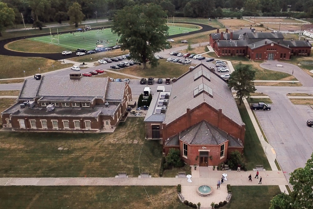 an aerial view of a school with cars parked in front of it