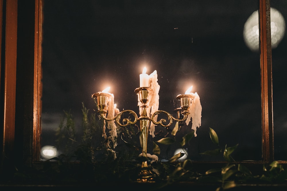 a candelabra with candles lit in a dark room