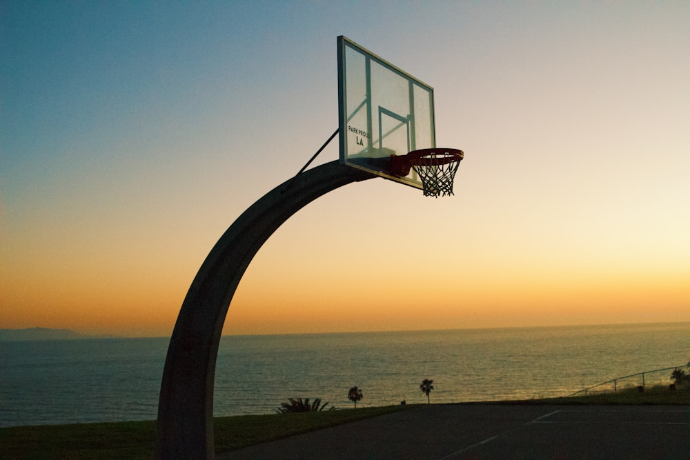 a basketball hoop in front of a body of water