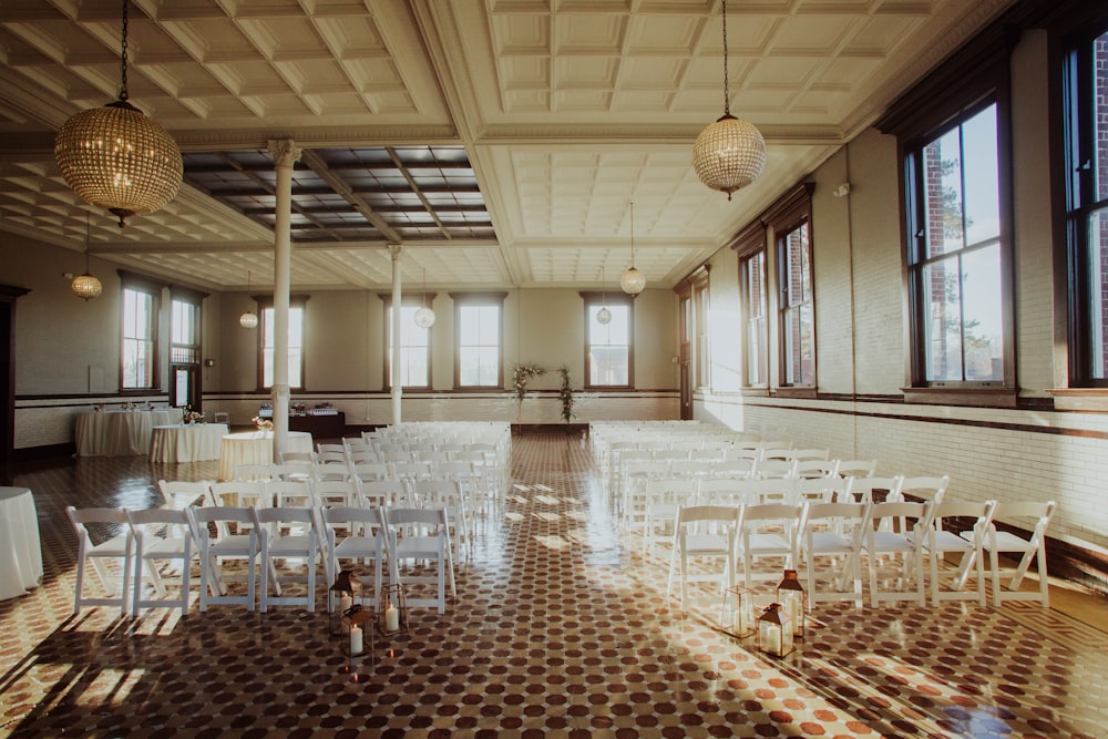 a large room with rows of white chairs