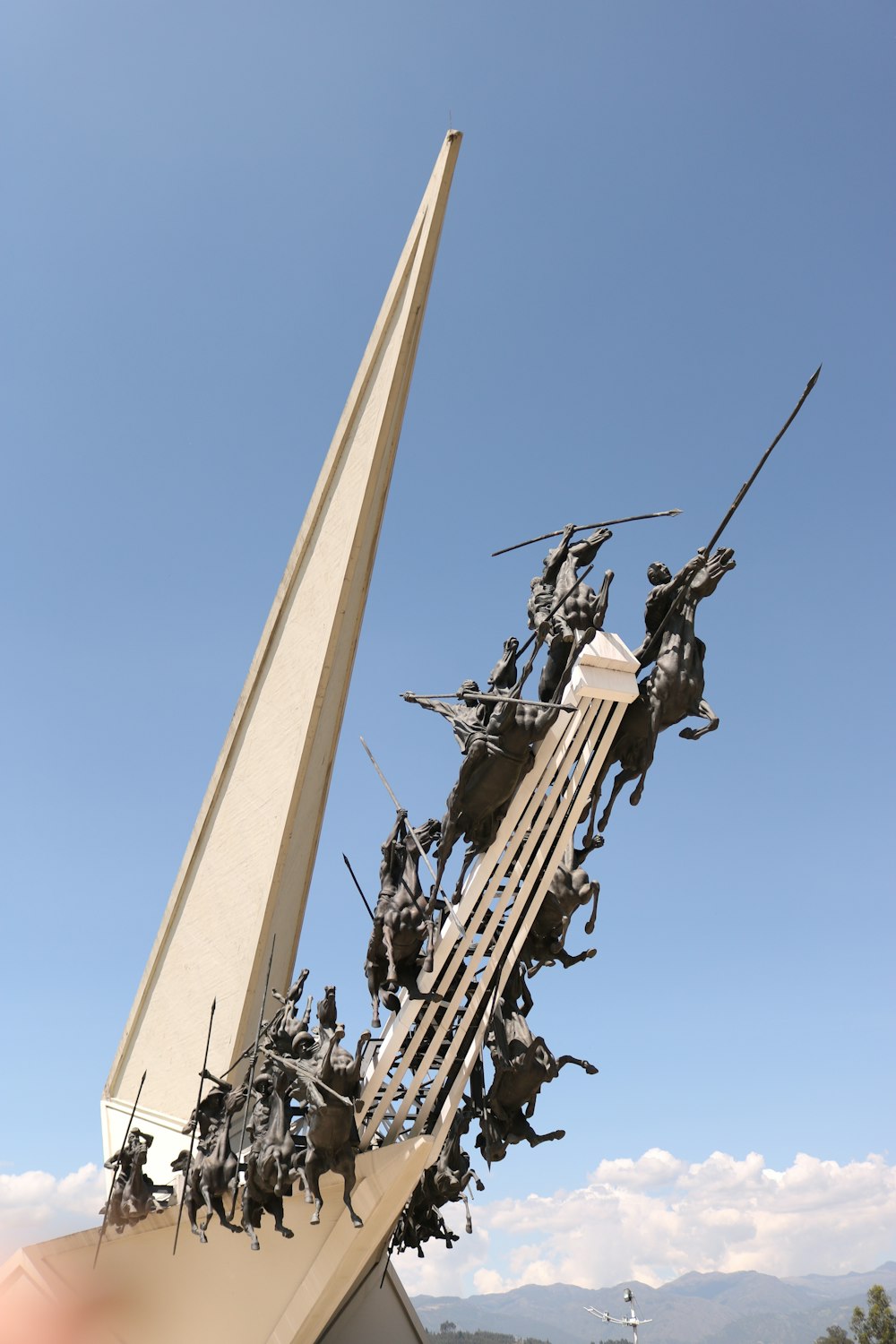 a sculpture of a group of people on a bridge