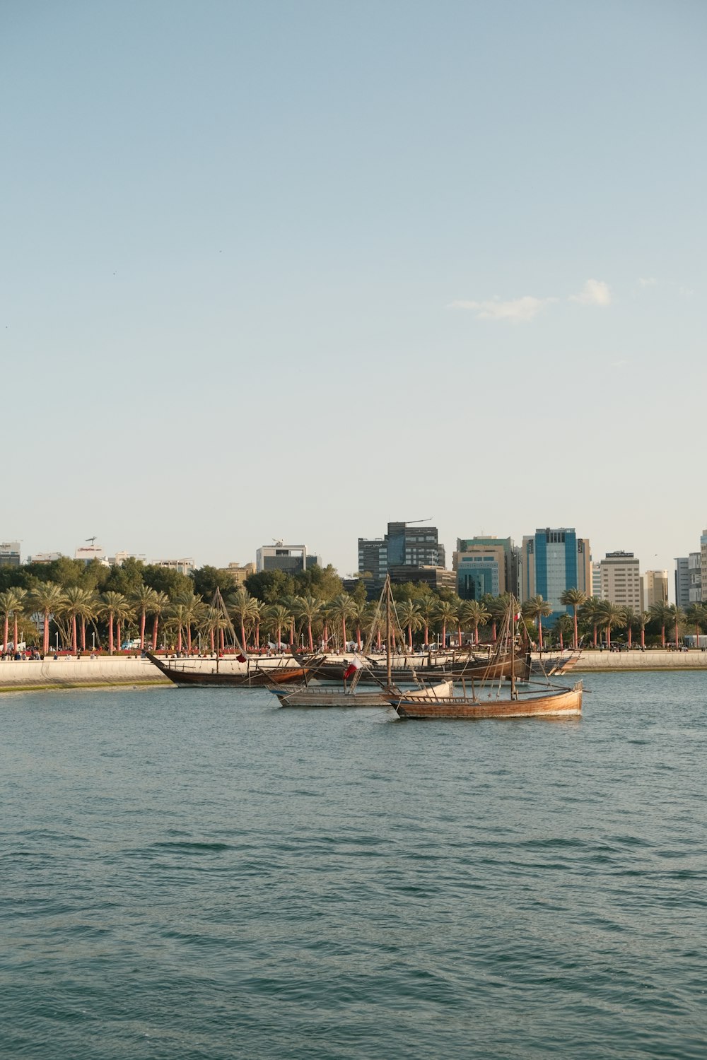 a couple of boats floating on top of a body of water