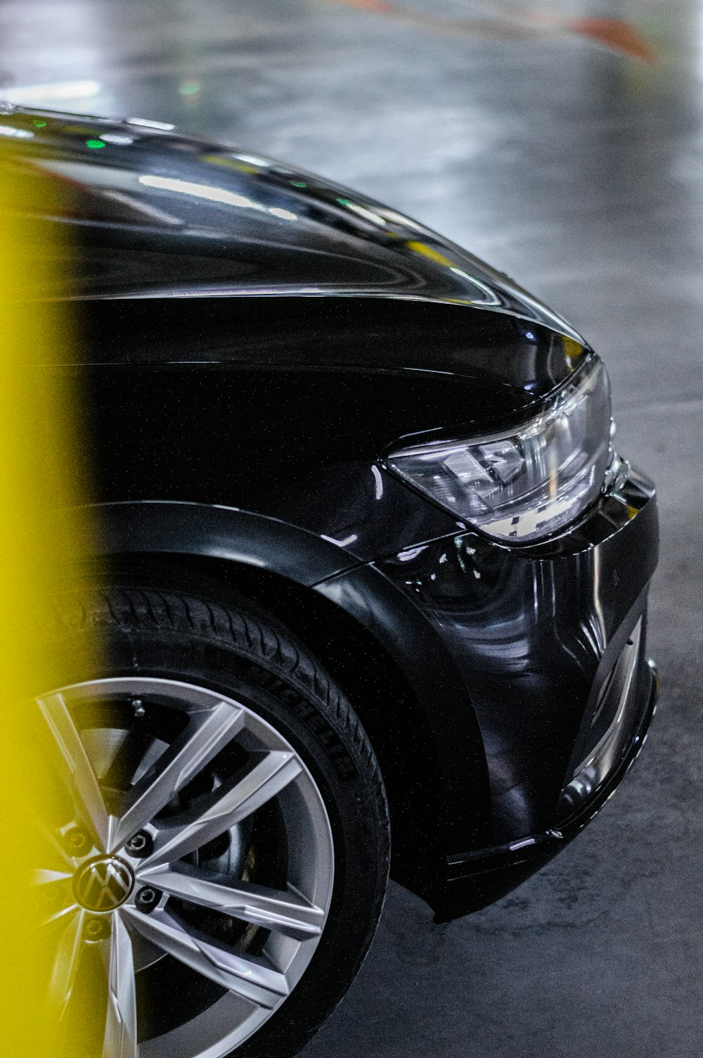 a black car parked in a parking garage