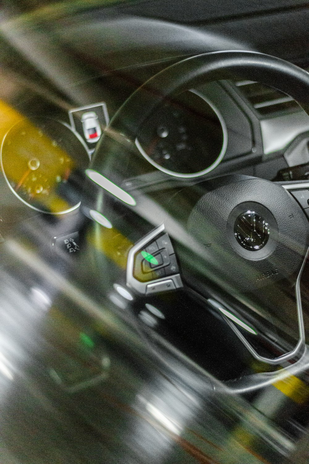 a car dashboard with a steering wheel and dashboard lights