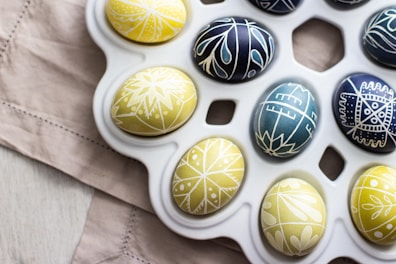 a tray of decorated eggs on a table