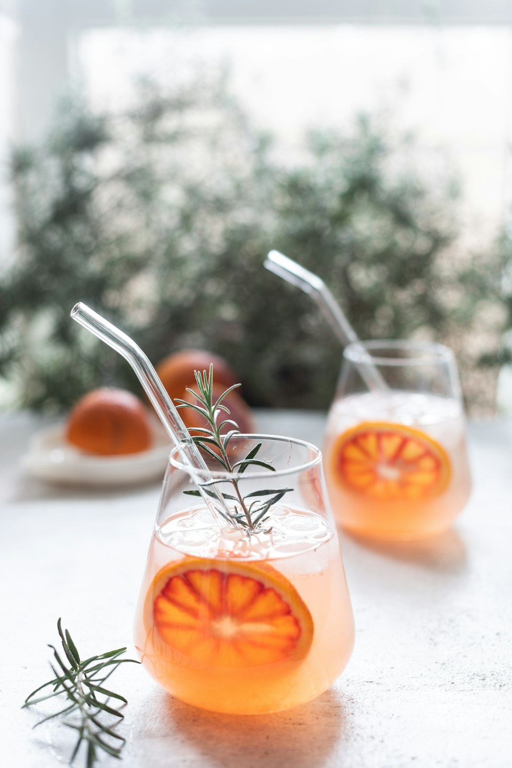 a couple of glasses filled with drinks on top of a table