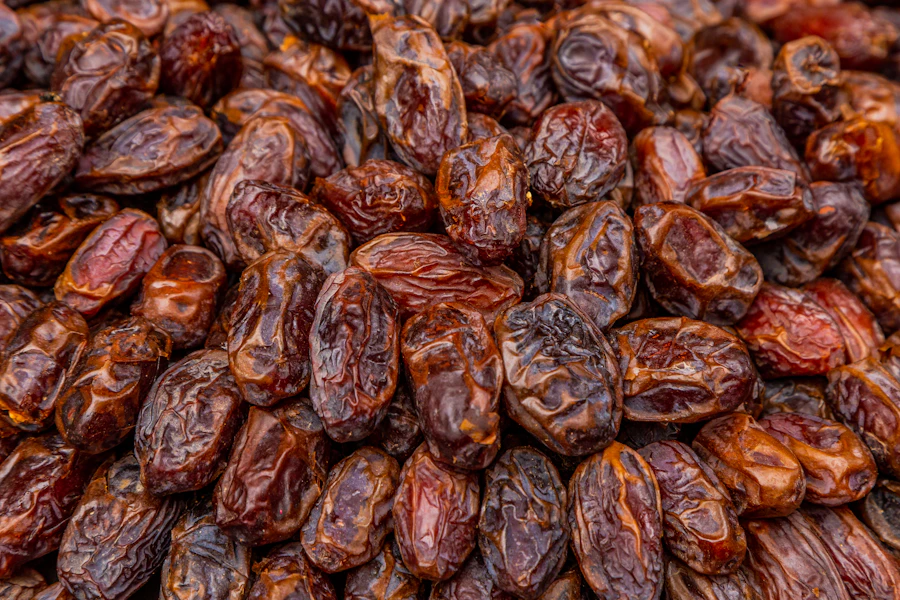 A dense pile of dark, dry dates seen from directly above