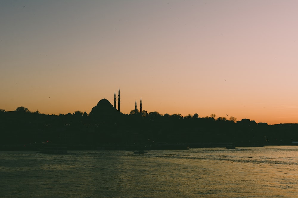 a large body of water with a church in the background