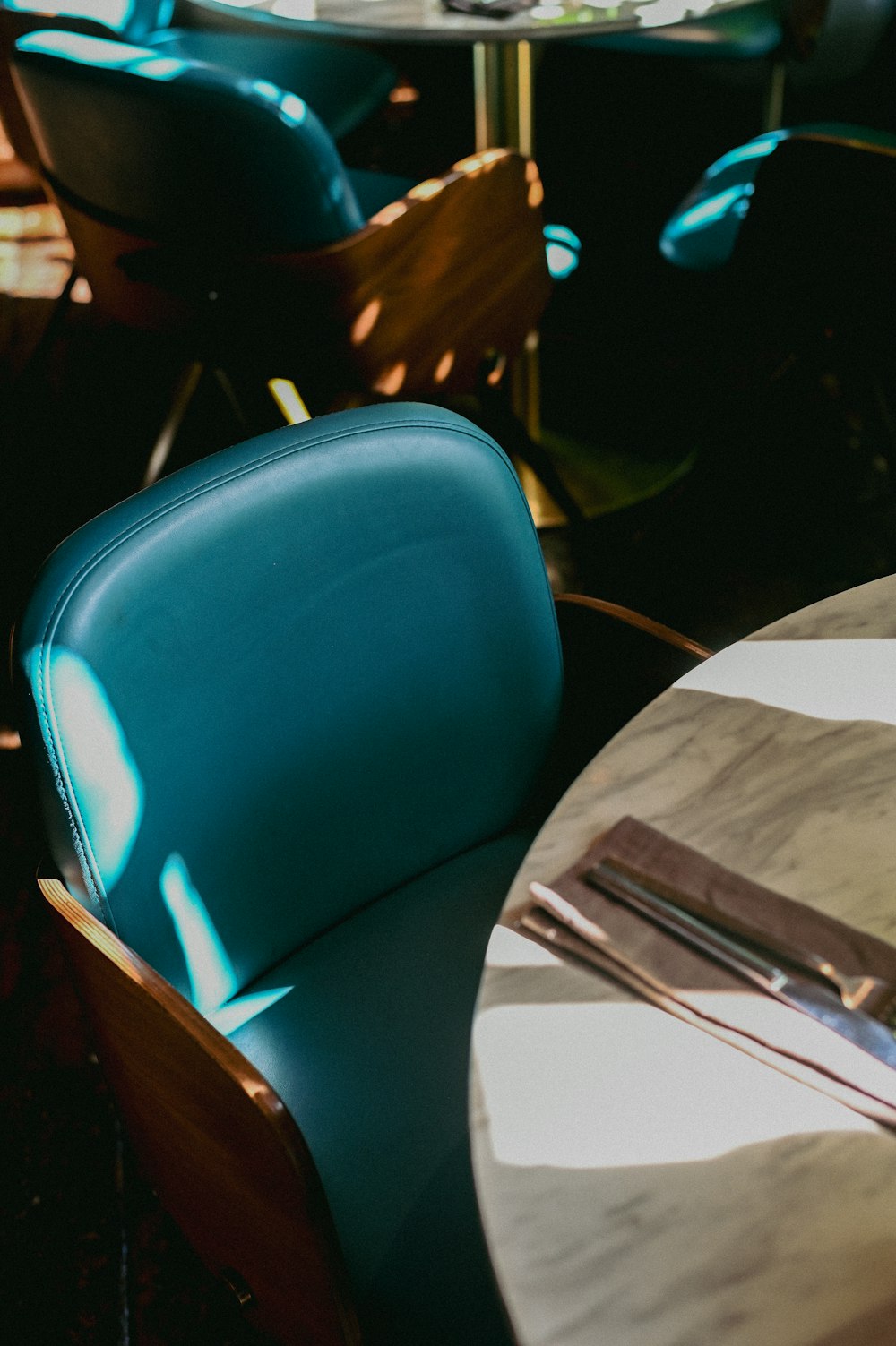 a table and chairs with a book on it