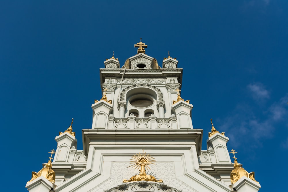 a tall white building with a clock on it's face