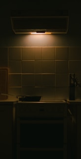 Close-up of a deep kitchen cleaning in progress, scrubbing stovetop and backsplash tiles