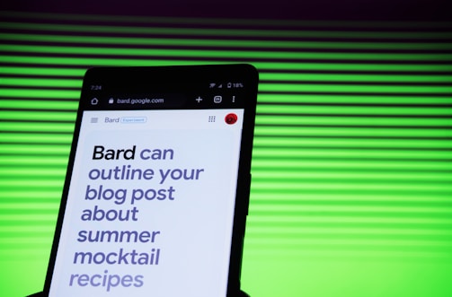 A smartphone screen displaying a webpage with large text about outlining a blog post for summer mocktail recipes. In the background, there is a pattern of horizontal green lines creating a vibrant backdrop.