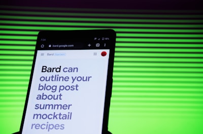 A smartphone screen displaying a webpage with large text about outlining a blog post for summer mocktail recipes. In the background, there is a pattern of horizontal green lines creating a vibrant backdrop.