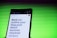 A smartphone screen displaying a webpage with large text about outlining a blog post for summer mocktail recipes. In the background, there is a pattern of horizontal green lines creating a vibrant backdrop.