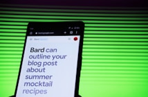 A smartphone screen displaying a webpage with large text about outlining a blog post for summer mocktail recipes. In the background, there is a pattern of horizontal green lines creating a vibrant backdrop.