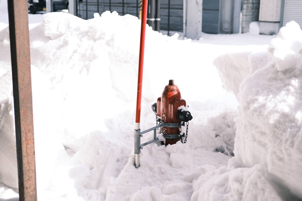 a fire hydrant in the middle of a pile of snow