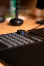 A close-up of hands on a keyboard with highlighted keys and a progress chart displayed nearby.