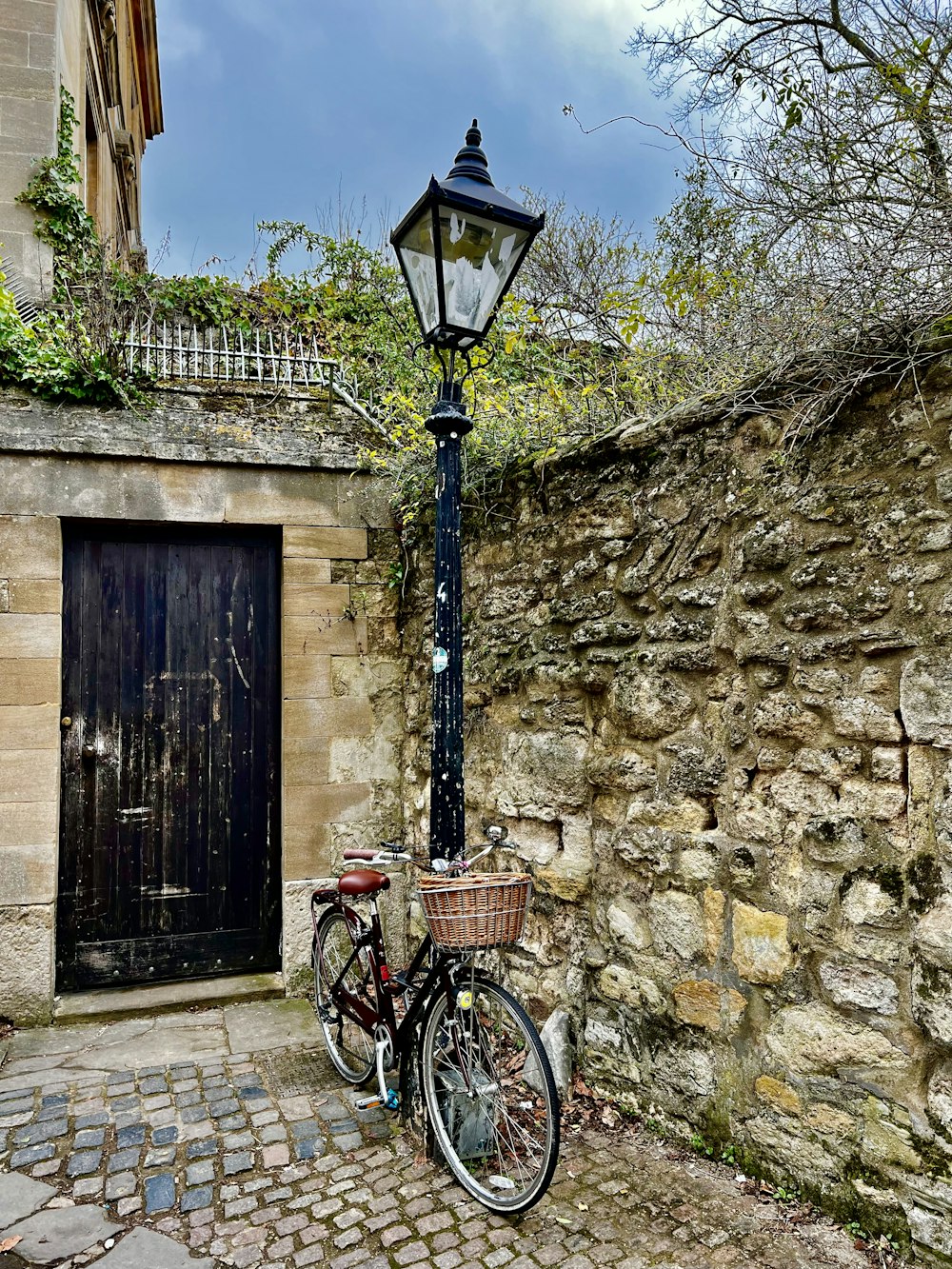 a bicycle parked next to a lamp post